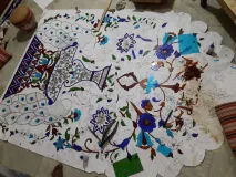 Behind the scenes: The intricate process of hand-cutting and placing mirror pieces for our custom Thikri artwork
